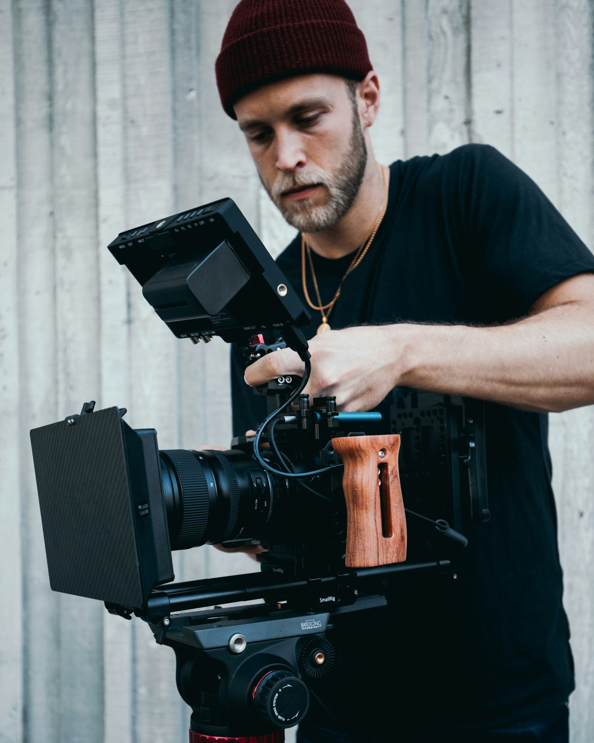 man in blue crew neck t-shirt holding black camera